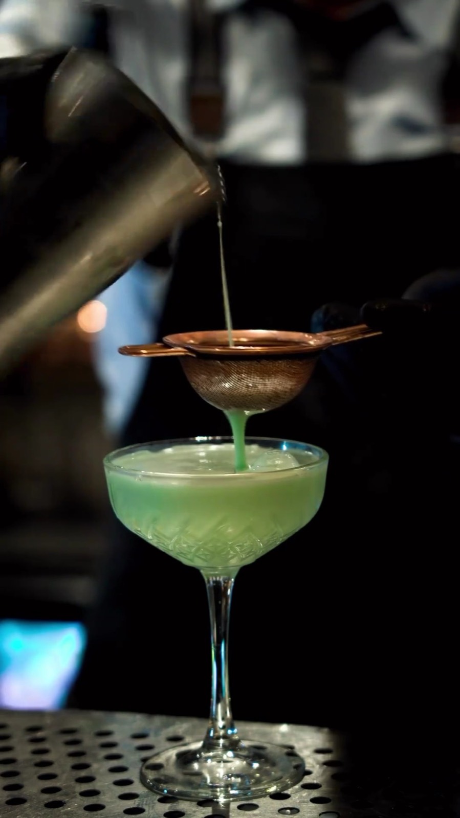 A fresh green cocktail in a coupe glass.